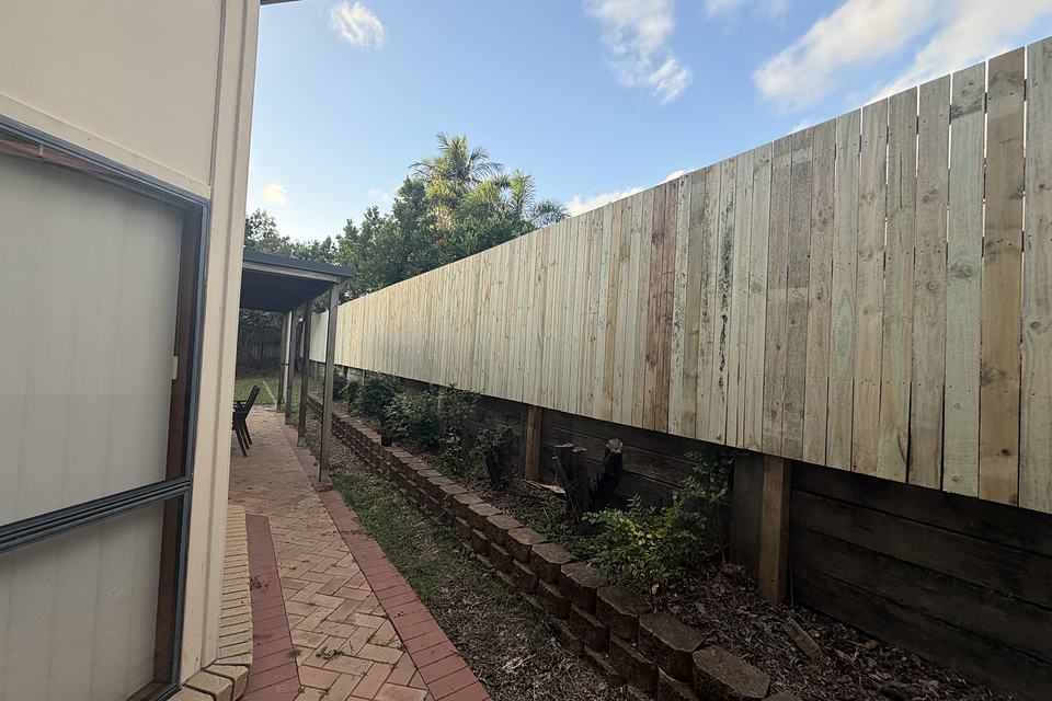 Timber paling fence running the full length of a side boundary