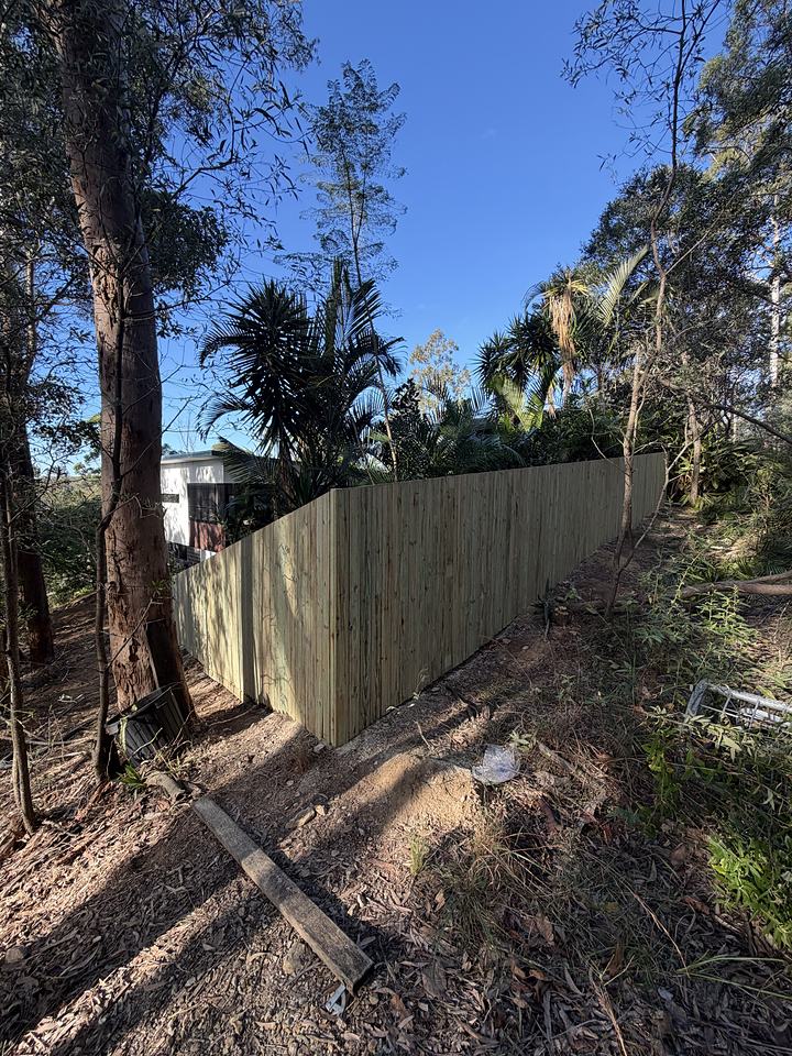 Timber paling fence along a boundary backing onto bushland