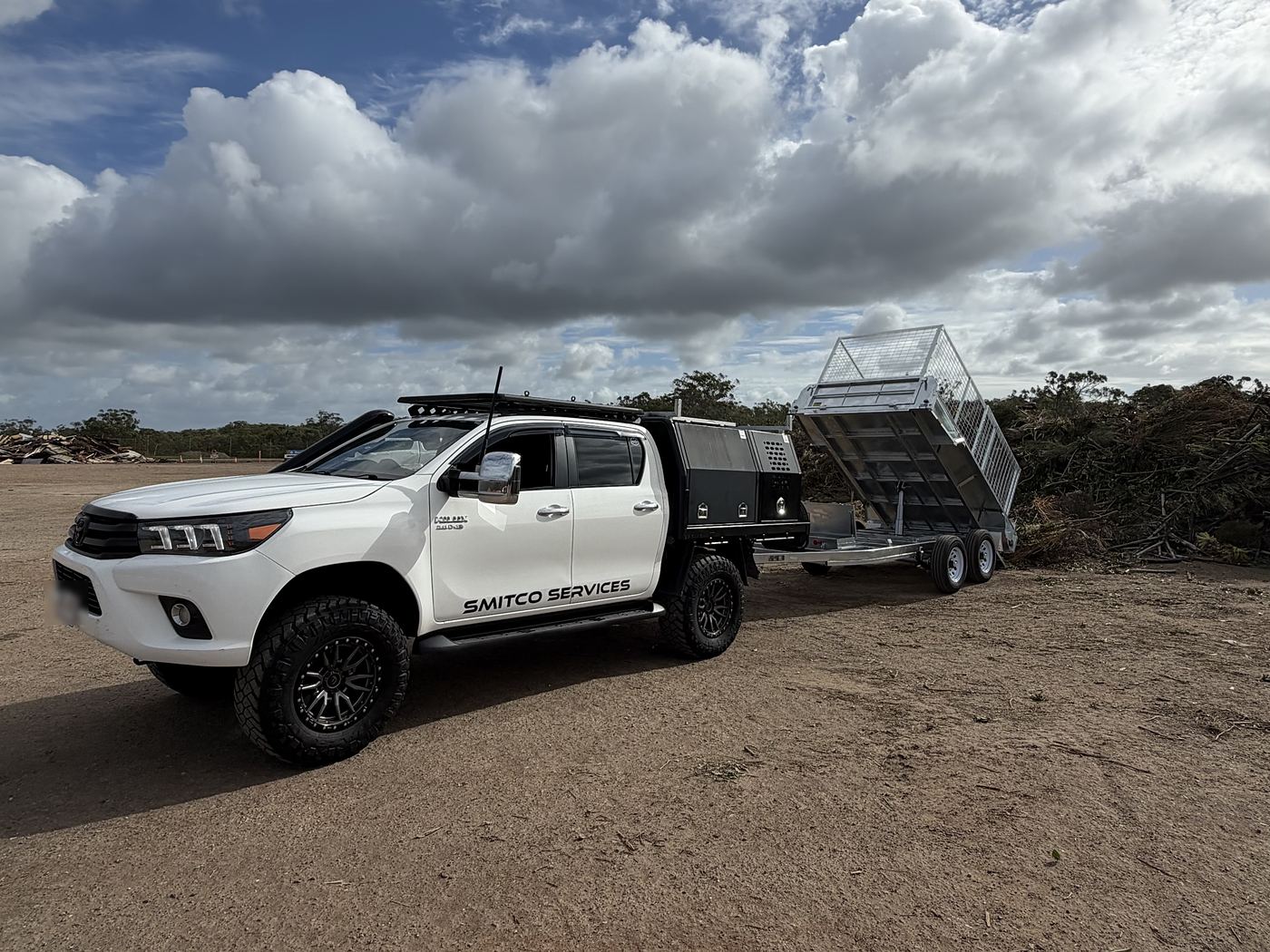 The Smitco Services ute and tipper trailer at a job site
